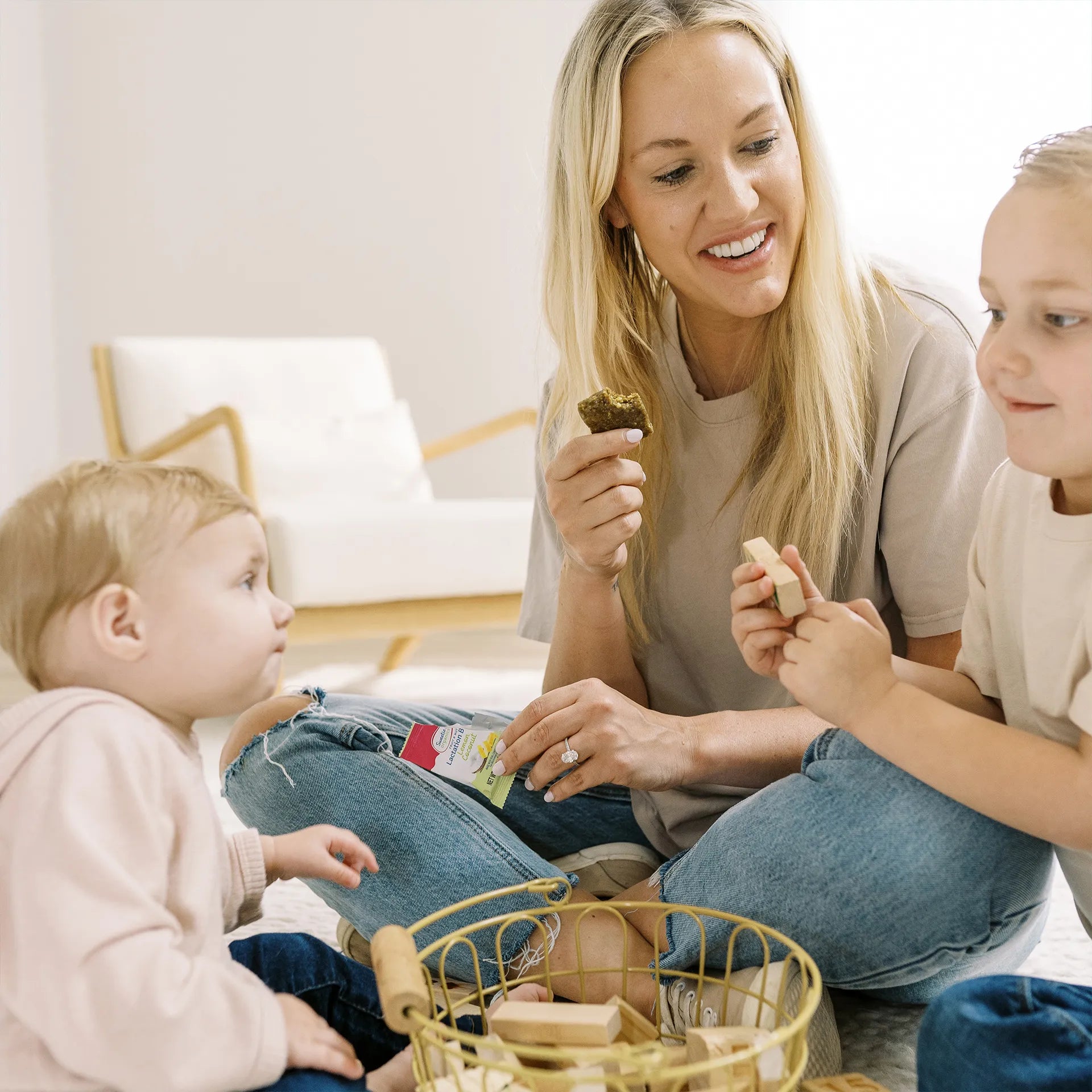 Parent with kids while holding a Lemon Coconut Lactation bite