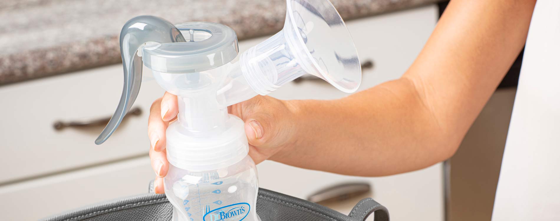 Person holding a breast pump