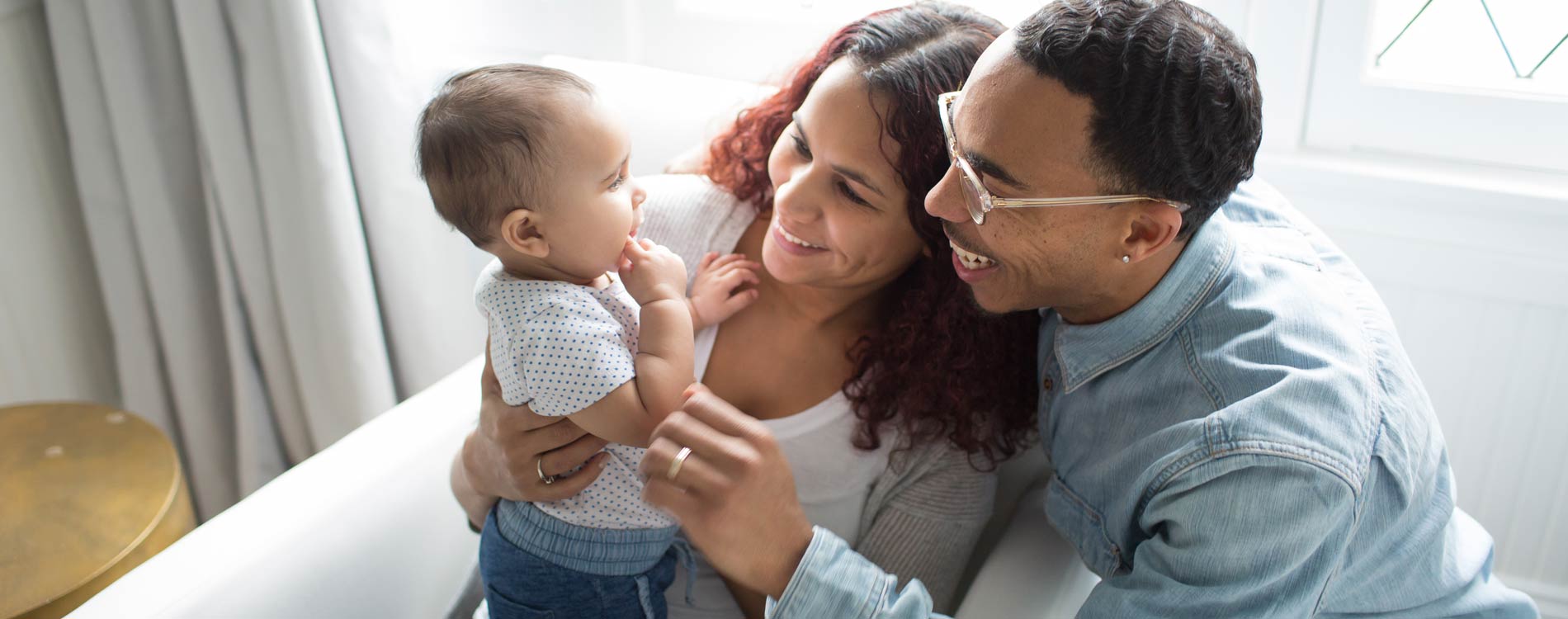 Parents sitting down and interacting with their baby