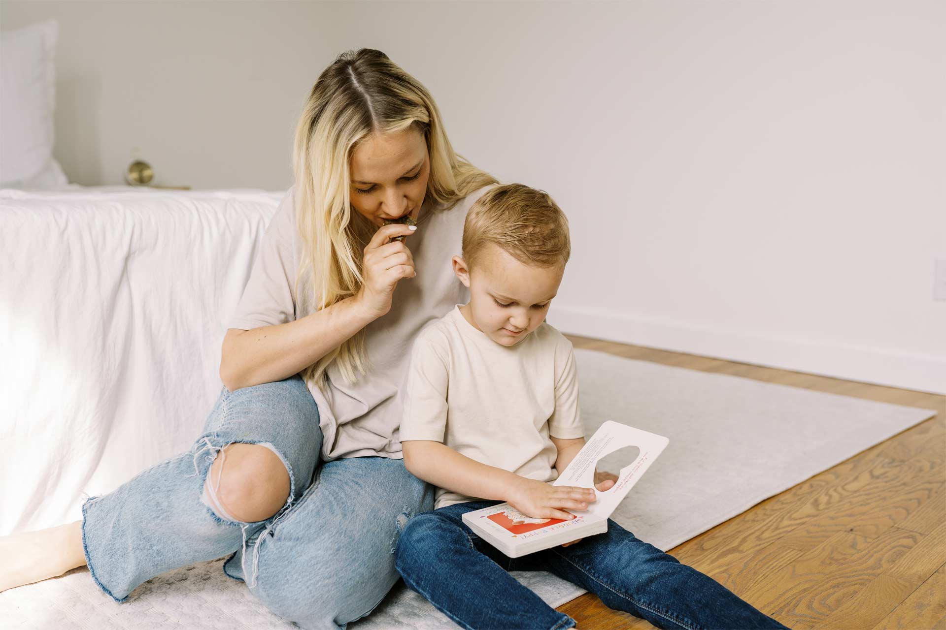 Parent reading with child while eating a lactation bite